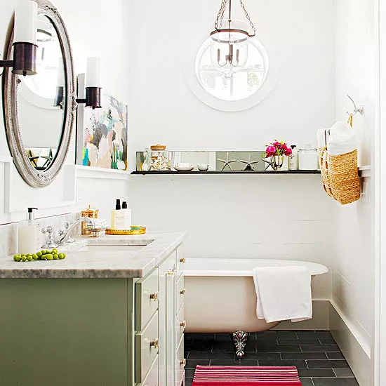 Decorating a vintage bathroom with thrifted finds like retro soap dishes and quirky signs