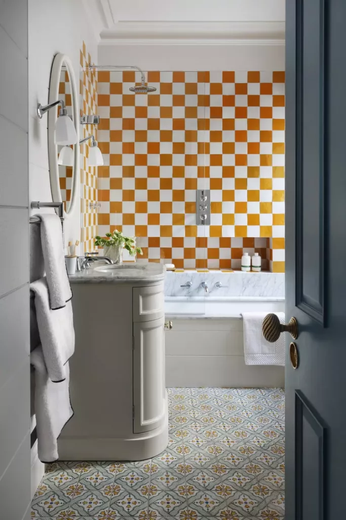 Funky bathroom with bold checkerboard walls and neutral accents and decor for a retro vibe