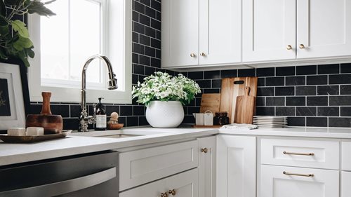 Black subway tiles with contrasting white grout for a modern kitchen backsplash