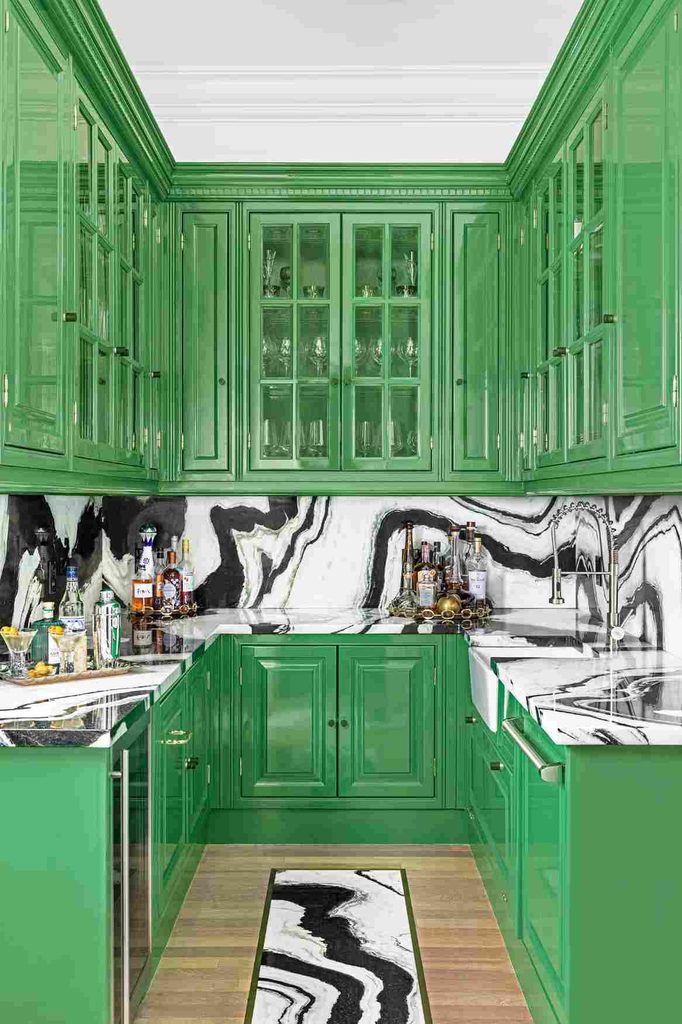 Black and white kitchen backsplash in bold marble with dramatic veining in a colorful modern kitchen