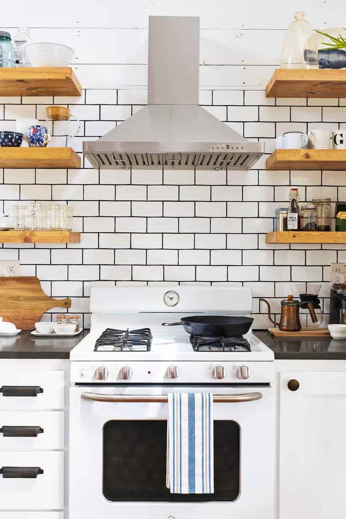 White subway kitchen wall tiles with black grout and irregular handmade edges