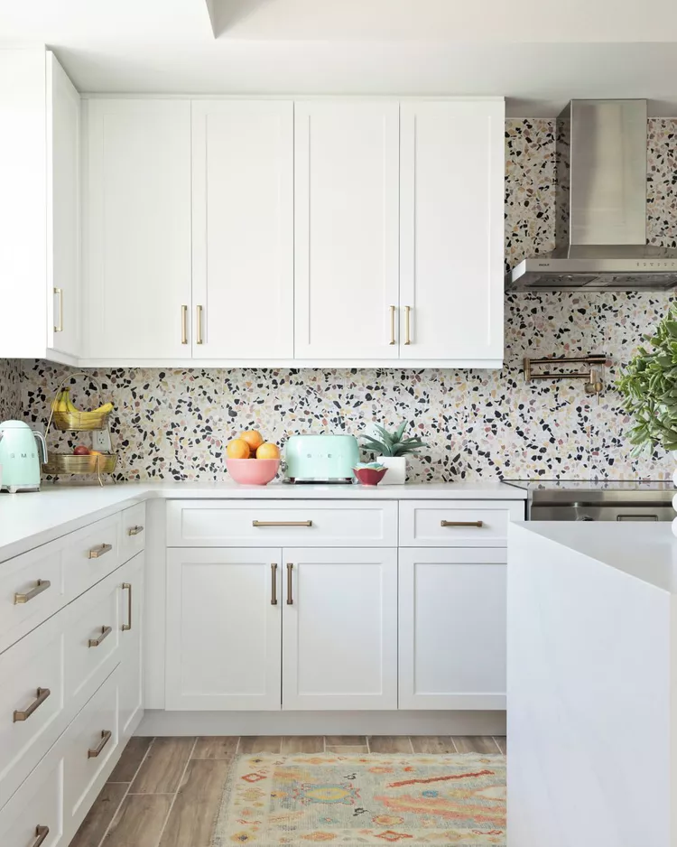 Black and white terrazzo tiles creating a textured and decorative kitchen backsplash
