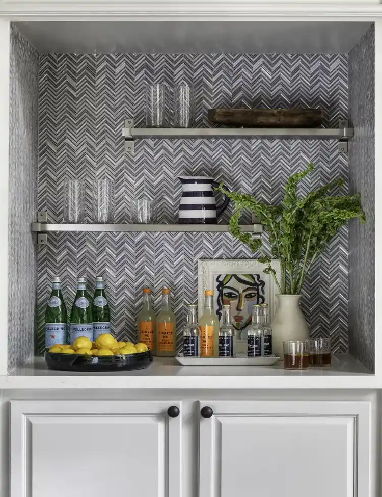 Black and white kitchen backsplash with patterned tiles in a decorative kitchen alcove