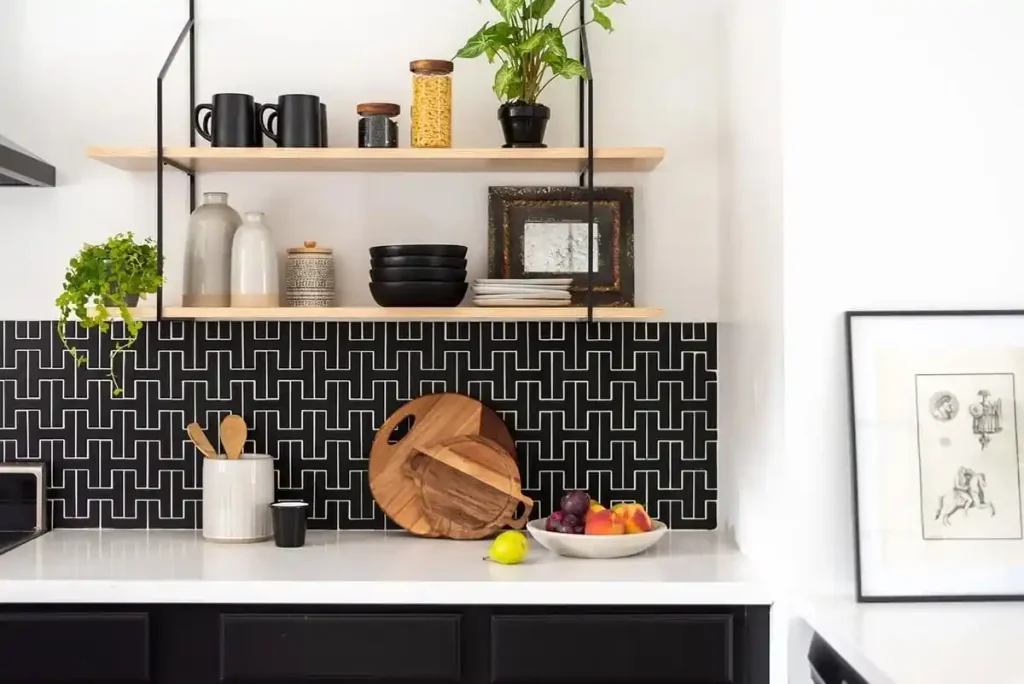 Black and white kitchen backsplash with an interlocking H-chain geometric tile pattern